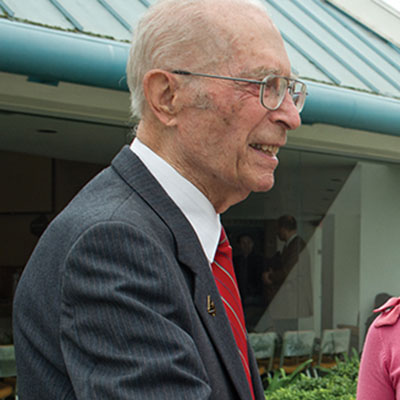 Alfred Neukuckatz talking to two female students outside the CU Center